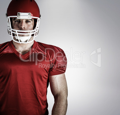 Composite image of american football player looking at camera