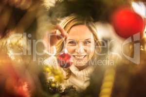 Festive blonde hanging bauble on christmas tree