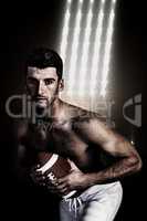 Composite image of portrait of shirtless rugby player posing wit