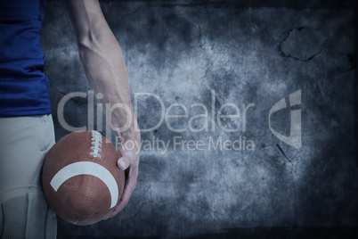 Composite image of midsection of sports player holding ball