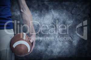 Composite image of midsection of sports player holding ball