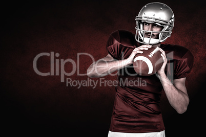 Composite image of american football player holding ball white l
