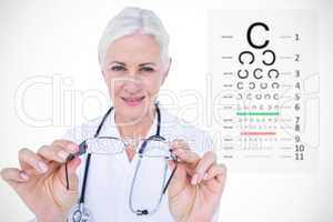 Composite image of smiling female optician presenting eye glasse
