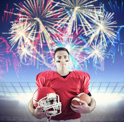 Composite image of american football player holding helmet