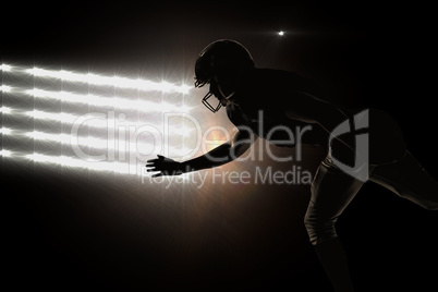 Composite image of silhouette american football player jumping