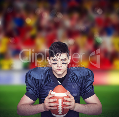Composite image of determined american football player holding a