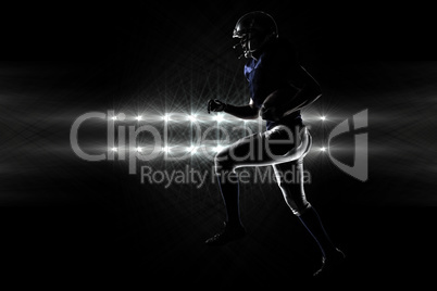 Composite image of silhouette american football player runing