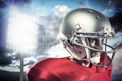 Composite image of confident american football player in red jer