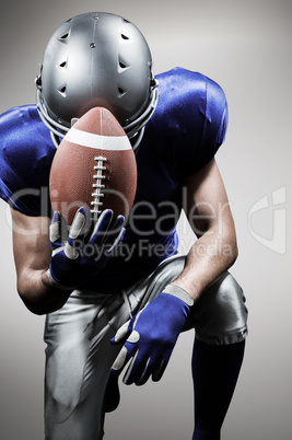 Composite image of upset american football player kneeling while