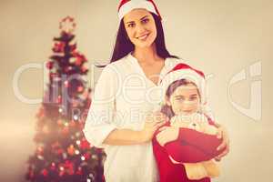 Festive mother and daughter smiling at camera