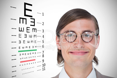 Composite image of geeky hipster looking at camera