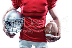 Midsection of American football player holding helmet and ball