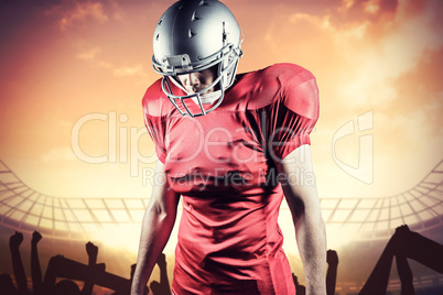 Composite image of american football player looking down while s