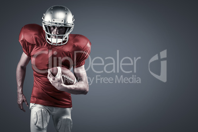 Composite image of portrait of american football player in red jersey running with ball