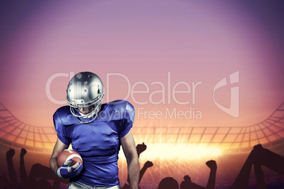 Composite image of american football player looking down while h