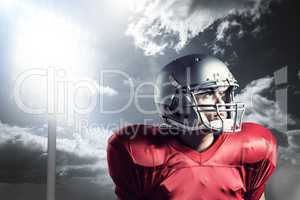 Composite image of american football player looking away while s