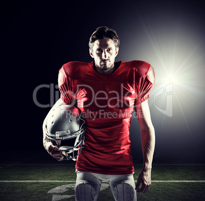 Composite image of american football player in red jersey holdin