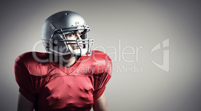 Composite image of american football player looking away while s