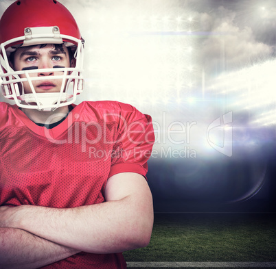 Composite image of american football player with arms crossed