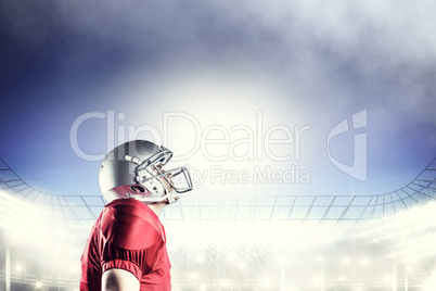 Composite image of american football player looking up while sta