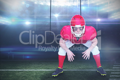 Composite image of american football player in attack stance