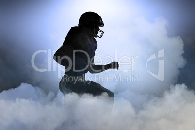 Composite image of silhouette american football player runing