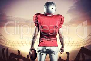 Composite image of rear view of american football player with ba