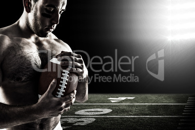 Composite image of shirtless american football player with ball