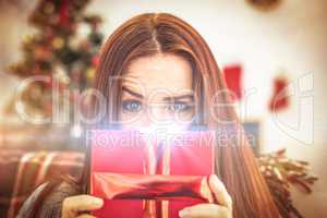 Festive redhead with gift on the couch