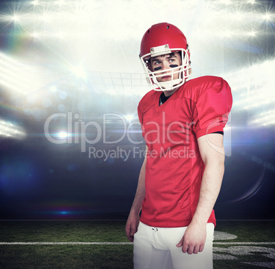 Composite image of serious american football player wearing a he