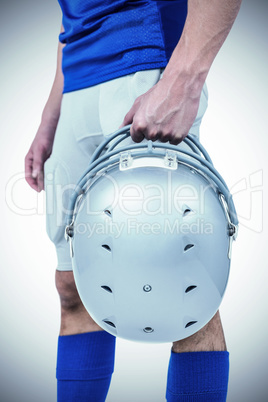 Sports player handing his helmet