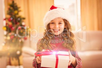 Festive little girl opening a gift Festive little girl opening a gift