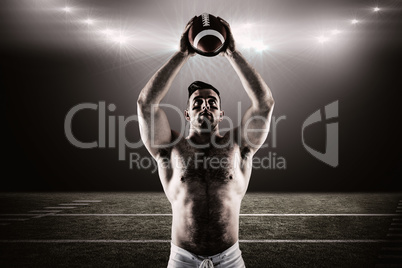 Composite image of shirtless american football player with ball