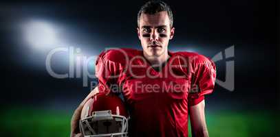 Composite image of a serious american football player looking at