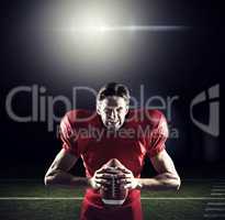 Composite image of aggressive american football player in red je