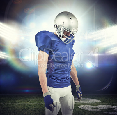 Composite image of american football player looking down