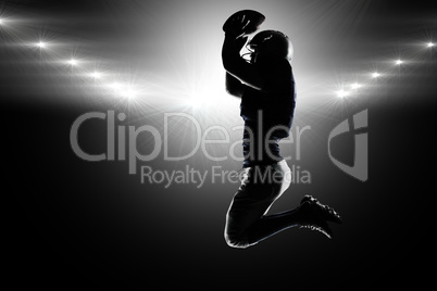Composite image of silhouette american football player jumping w