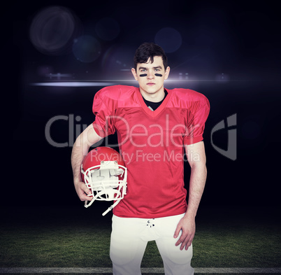 Composite image of american football player holding helmet