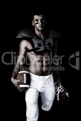 Composite image of portrait of rugby player holding ball and hel