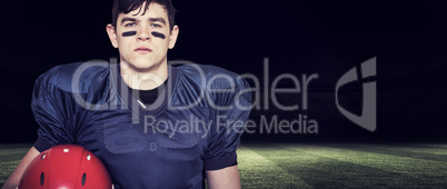 Composite image of american football player holding an helmet Composite image of american football player holding an helmet