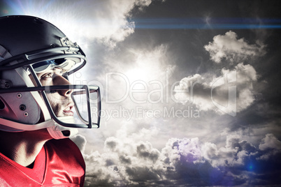 Composite image of american footballer looking up