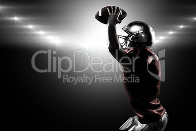 Composite image of sports player in red jersey holding ball