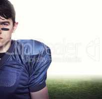 Composite image of american football player looking at the camer
