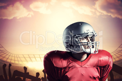 Composite image of american football player looking away while s