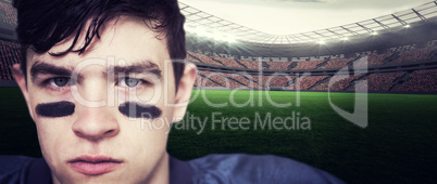 Composite image of american football player looking at the camer