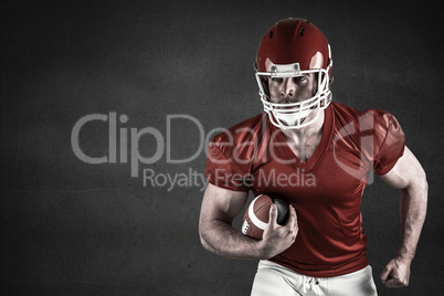 Composite image of american football player holding ball