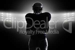 Composite image of silhouette american football player standing
