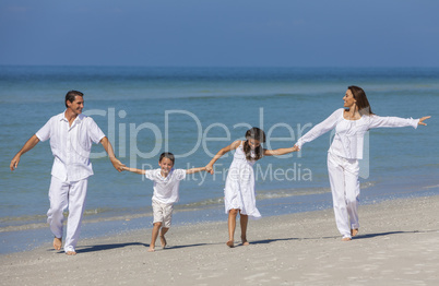 Mother, Father and Children Family Running Having Fun At Beach