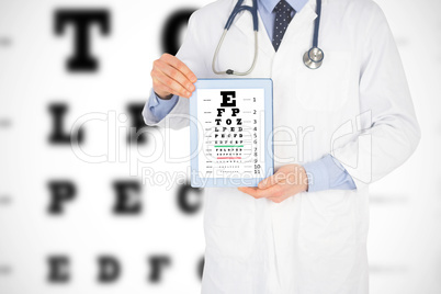 Composite image of doctor showing a digital tablet