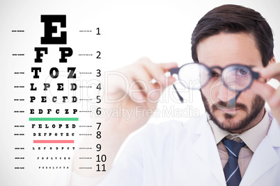 Composite image of doctor wearing lab coat looking through eyegl